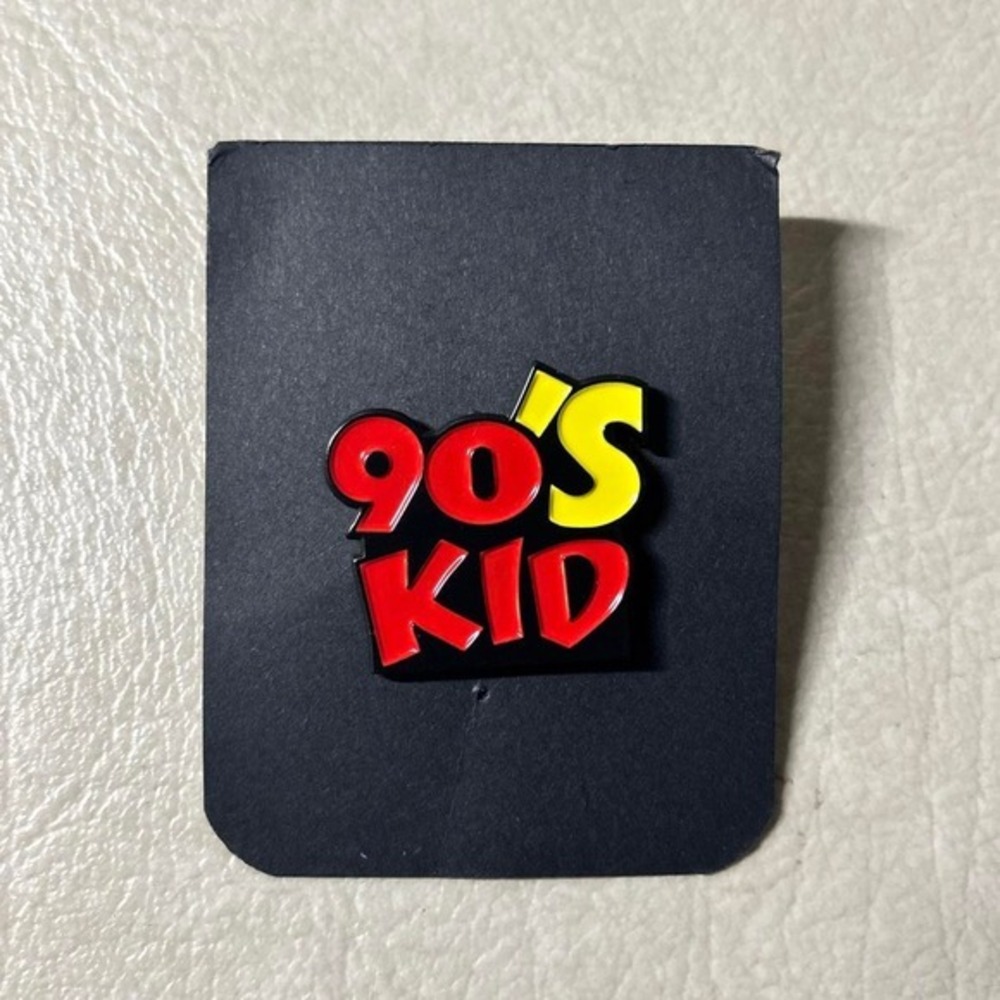 90s Kid enamel pin with red and yellow text reading '90'S KID'